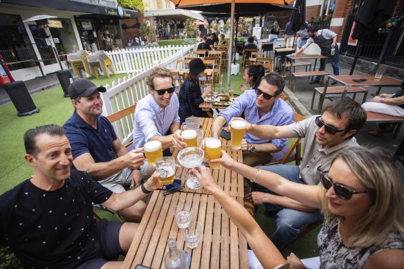 A group of friends gather to celebrate the easing of restrictions at Yarraville on Friday.