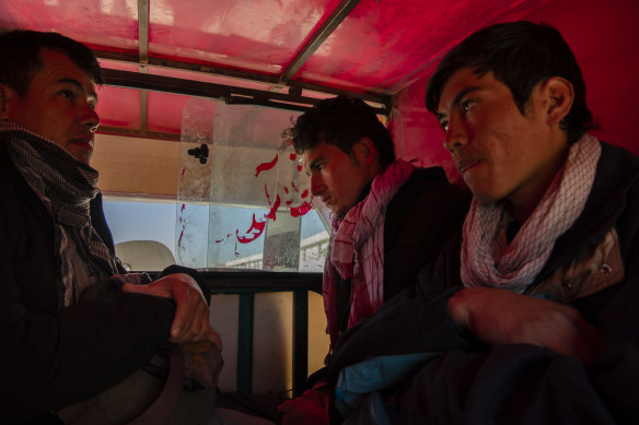 Migrants load up in the back of a rickshaw to be transported to a safe house, where they will wait until the sun sets before being moved closer to the border, in Zaranj, Afghanistan.