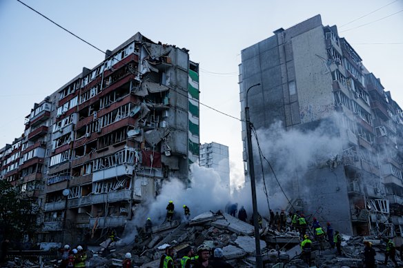 Rescue workers clear the rubble of a house heavily damaged after a Russian strike on a residential neighbourhood in Kyiv, Ukraine yesterday. 