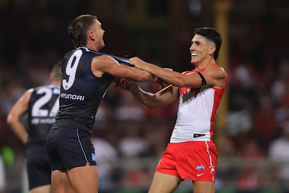 Patrick Cripps scuffles with Justin McInerney during opening round.