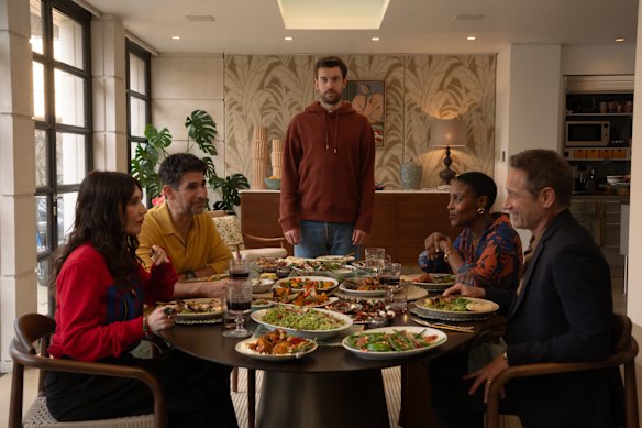 Jack Whitehall (standing), with (clockwise from left) Carice van Houten, Raza Jaffrey, Christine Adams and David Duchovny in Malice.
