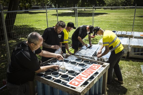 Pyrotechnicians prepare the fireworks for Melbourne’s New Year’s Eve display in the Kings Domain.