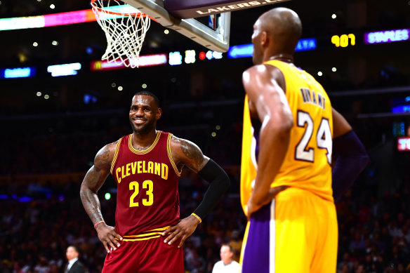 LeBron James and Kobe Bryant share a joke during a 2016 NBA match.