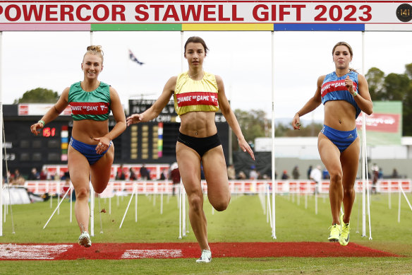 Bella Pasquali (centre) crosses the line first in the Stawell Gift on Monday.
