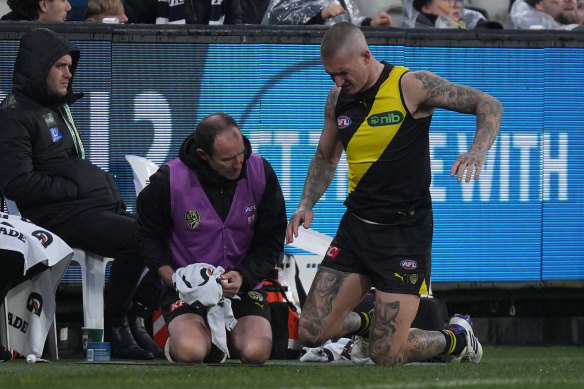 Dustin Martin receives medical treatment on the sidelines.