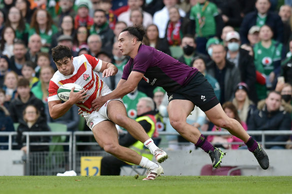 Kazuki Himeno of Japan is tackled by James Lowe of Ireland.