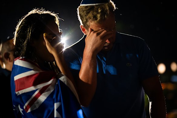 A couple mourns at a candlelight vigil in the days after the attack at Bondi. 