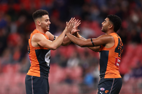  Jake Riccardi of the Giants, left, celebrates with Callum M. Brown. 