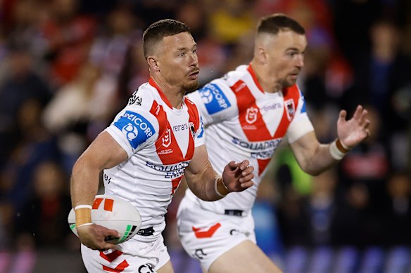 Damien Cook runs the ball.