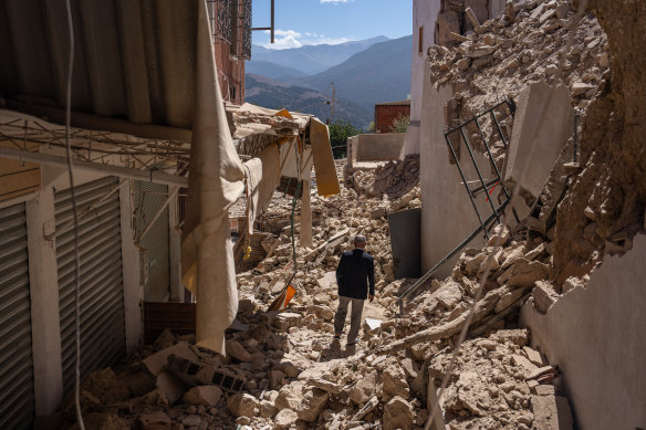 A man walks among the rubble in the town of Moulay Brahim in the High Atlas Mountains. 