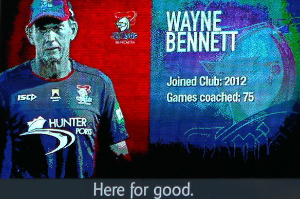 A photo of Wayne Bennett appears on the large screen after coaching his last game for the Knights in 2014 - with some unfortunate signage underneath it.