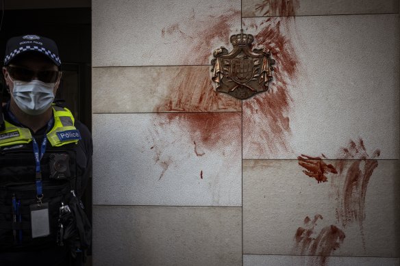 Handprints in fake blood on a coat of arms outside the British Consulate in Melbourne.