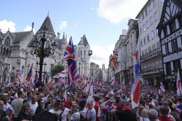 People take part in a protest march organised by Tommy Robinson, in central London, Saturday July 27.