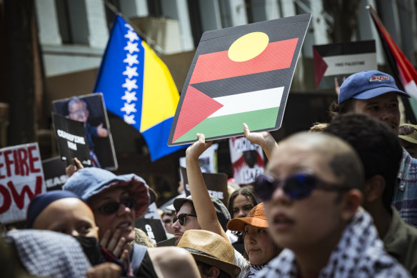 Protesters in Melbourne on Sunday brandish the Palestinian and Aboriginal flags.