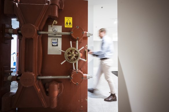 Guardian Vaults manager Chris Blematl carries a safety box into a vault.