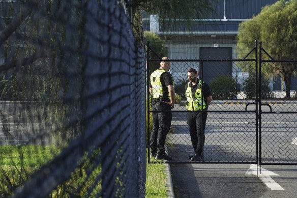 Security guards outside the Woolworths Melbourne South Regional Distribution Centre  on Monday. 