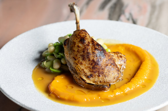 Slow-cooked duck leg with pumpkin puree, broad beans, cannellini beans, peas and orange jus. 