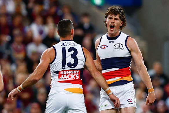 Daniel Curtin celebrates a goal with Taylor Walker.