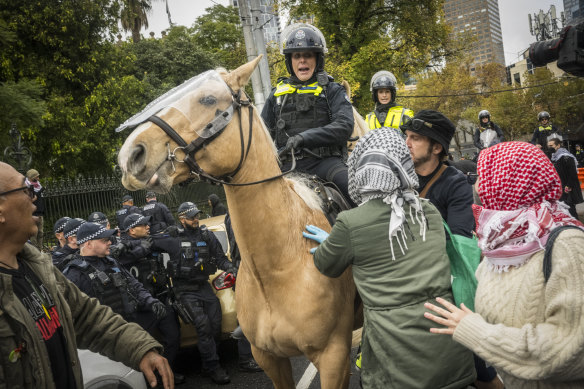 Police clash with pro-Palestine protesters in Melbourne on Sunday.