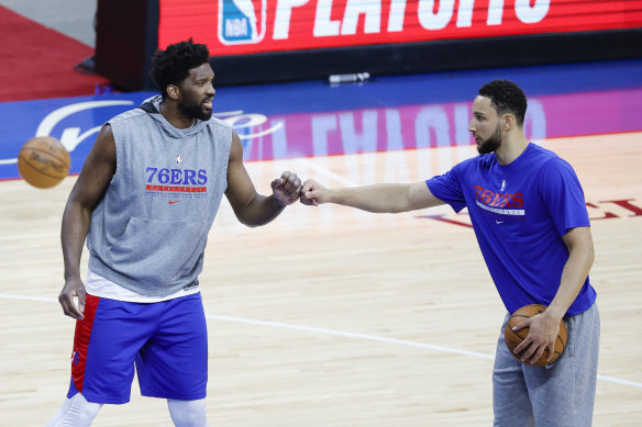 Injured star Joel Embiid with Simmons pre-match.