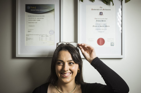 Jess Deller-Klatt next to her ATAR results and her master’s in social work.