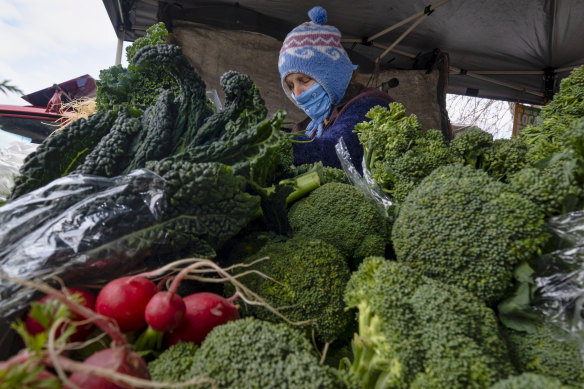 Sophia Stasey selling vegetables at the Bendigo Farmers Market. 