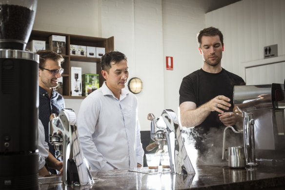 Head barista Matt Coulson talks customers Helen, Chris and Tin through making their own coffee.
