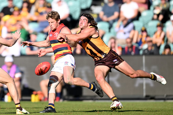 Hawthorn’s Jai Newcombe tackles Adelaide’s Rory Sloane in the round six clash at  UTAS Stadium, Launceston.