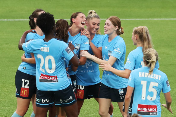 Charlize Rule celebrates with teammates after scoring the opener against Wellington. 