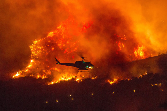 A helicopter prepares to drop water at a wildfire in Yucaipa, California, in September. The UN says the number of natural disasters has doubled this century. 