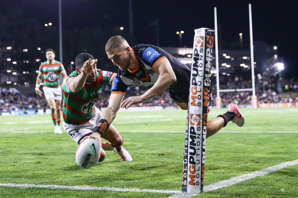 Adam Doueihi crosses for a try in the corner for Wests Tigers.