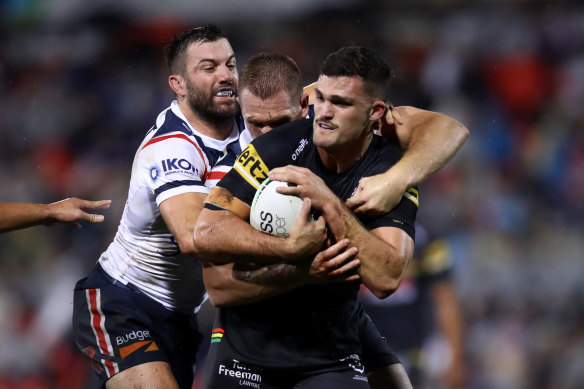 Panthers halfback Nathan Cleary comes in for some special attention from the Roosters’ defence led by James Tedesco.