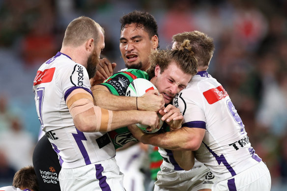 Souths centre Campbell Graham is tackled by the Storm defence.