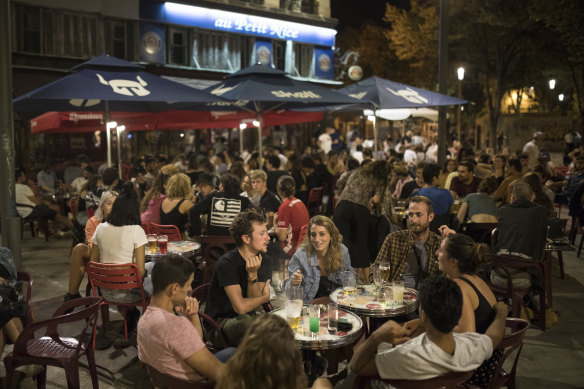 Friends have a drink together at a bar in Marseille, southern France, on Saturday, September 12, as new daily cases of COVID-19 passed 10,000 for the first time. 