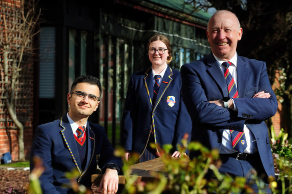 Hume Anglican Grammar school captains Eryn McKenna and
Meles Nona with principal Bill Sweeney.