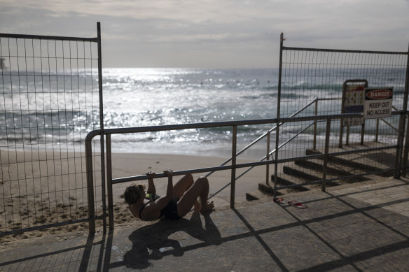 Some would not be deterred from their morning swim despite health warnings and physical barriers at Bronte Beach.