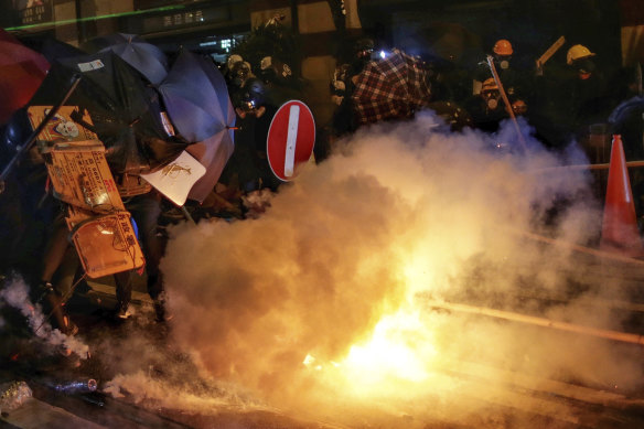 Tear gas canisters are fired at protesters on the streets of Hong Kong on Sunday night. 