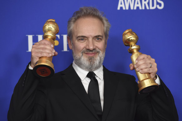 Sam Mendes poses with the awards for best director and best motion picture, drama for 1917.
