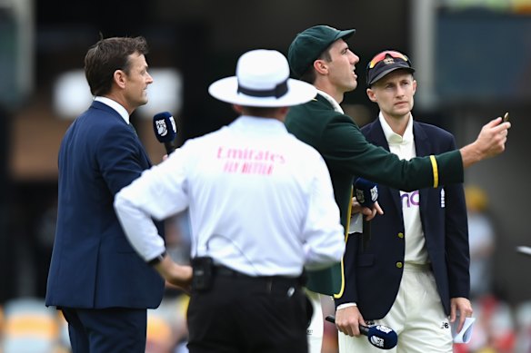 Cummins tosses the coin as England captain Joe Root calls.