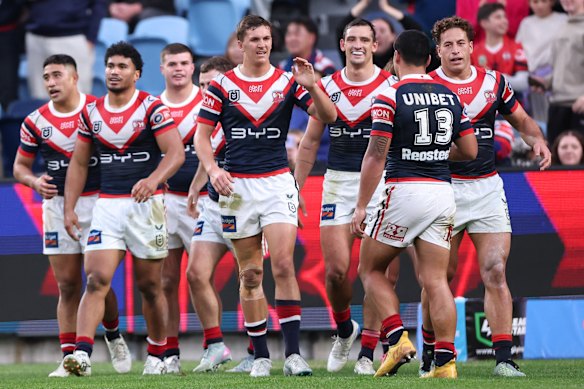 The Roosters celebrate a try for Connor Watson. 