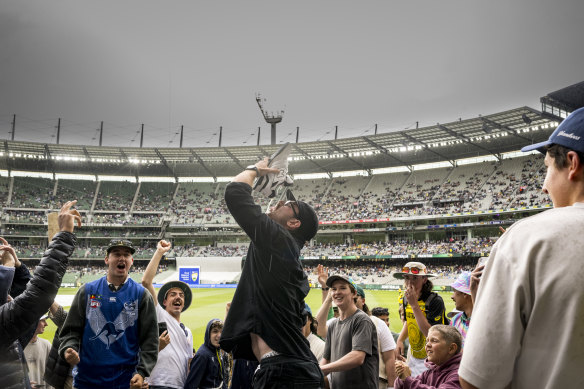 Fans make their own fun during a rain delay.