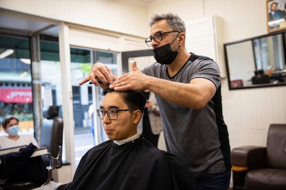 Yarraville Barber Henry Minassian cutting Tim Su’s hair on the first day out of lockdown.