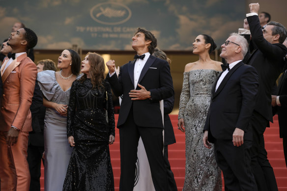 Cruise, centre, with Greg Tarzan Davis, Keleigh Sperry, Linda Bruckheimer, Jennifer Connelly, festival director Thierry Fremaux, and Jon Hamm during the fighter jets show.