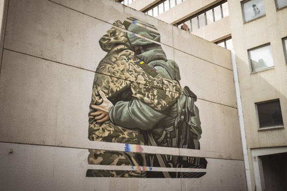 Peter Seaton’s mural in South Melbourne depicting a Ukrainian and a Russian soldier embracing has been painted over.