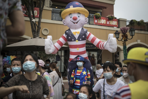Clowns interact with residents in the Chinese city of Wuhan, believed epicentre of the coronavirus pandemic, on Sunday.