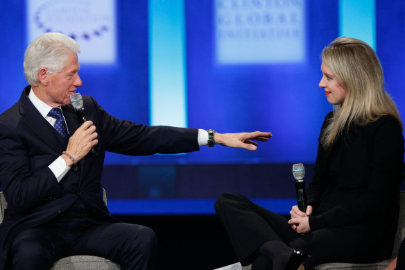 Holmes (pictured here with former US president Bill Clinton) rubbed shoulders with political and business elite before her world came crashing down.