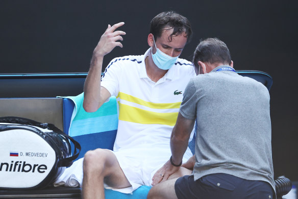 Daniil Medvedev of Russia receives treatment following victory. 