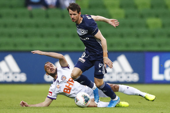 Robbie Kruse, right, and Ivan Franjic, left, contest the ball. 