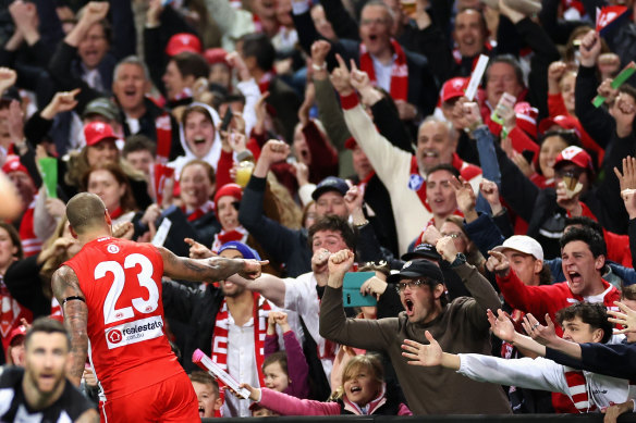 Lance Franklin celebrates a goal with part of the near record AFL crowd of more than 46,000 at the SCG on Sunday.