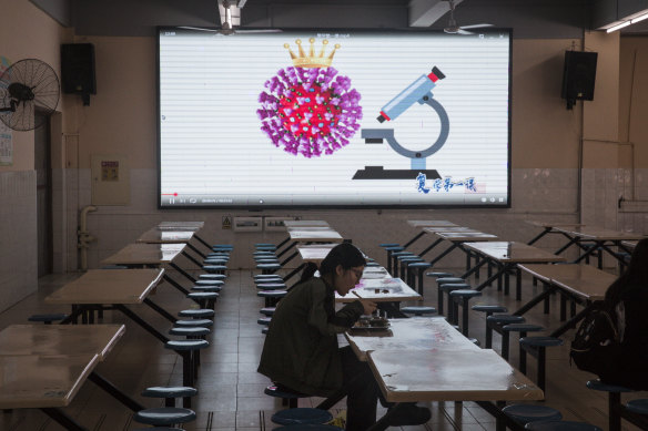 A senior student has lunch at the Wuhan Rayson School canteen. Widespread testing is seen as key to public confidence in reopening the economy.